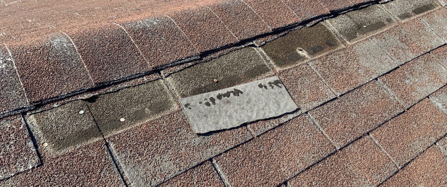 Damaged asphalt shingle roof